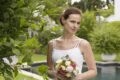 bride at poolside holding bouquet