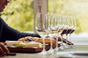 man enjoying a cheese platter and tasting different wines