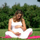 pregnant woman sitting on grass