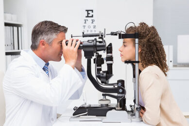 Woman doing eye test with optometrist